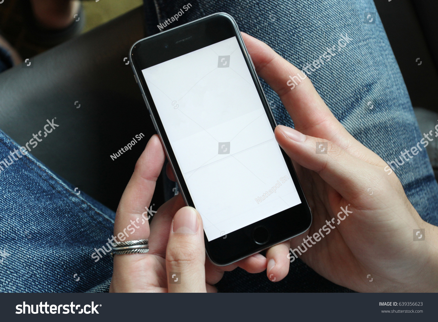 Closeup on a man's hands as he is using a smart phone. #639356623