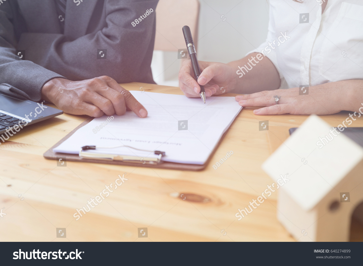 woman's hand hold ballpoint pen writing on  agreement paper sheet, fill in document template, applying for mortgage loan #640274899