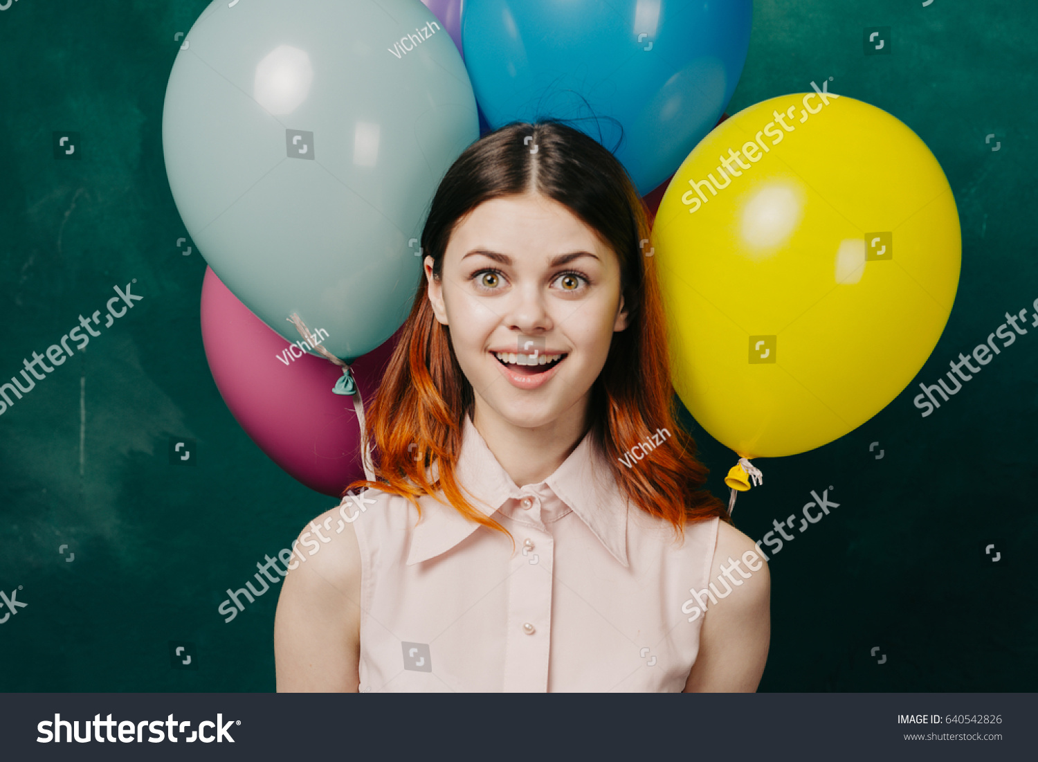 Joyful woman with balloons, the girl is happy, the girl is smiling with joy, joy and happiness #640542826