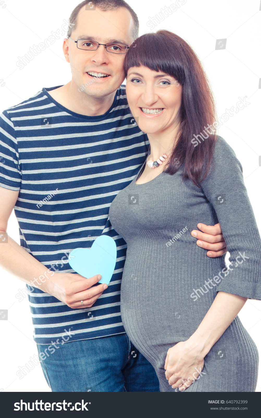Vintage photo, Happy smiling pregnant woman and her husband with heart of paper, concept of extending family and expecting for newborn #640792399
