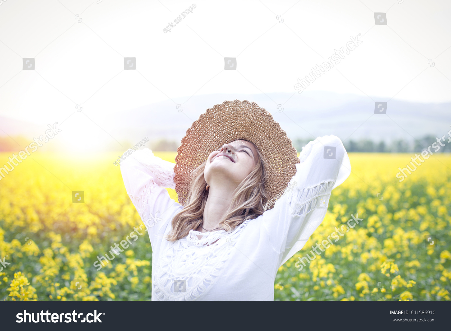 young woman in a rapeseed field #641586910