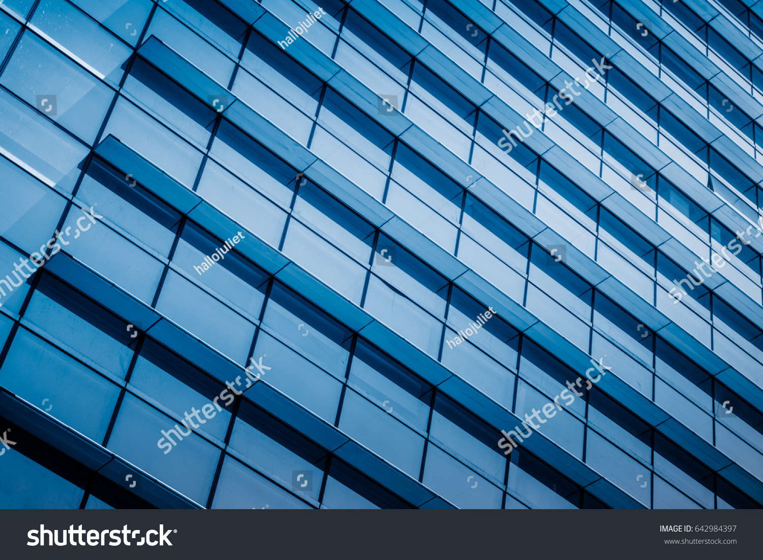 closeup of glass wall of modern building #642984397