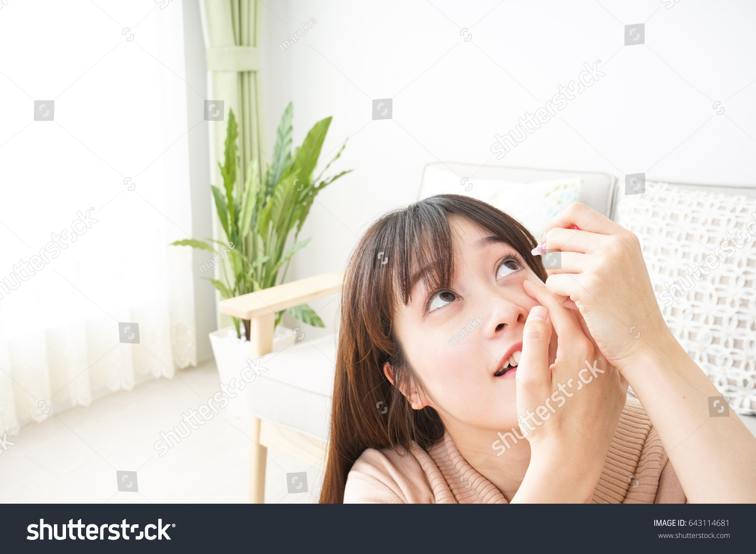 Young woman getting the medicine in the eye #643114681