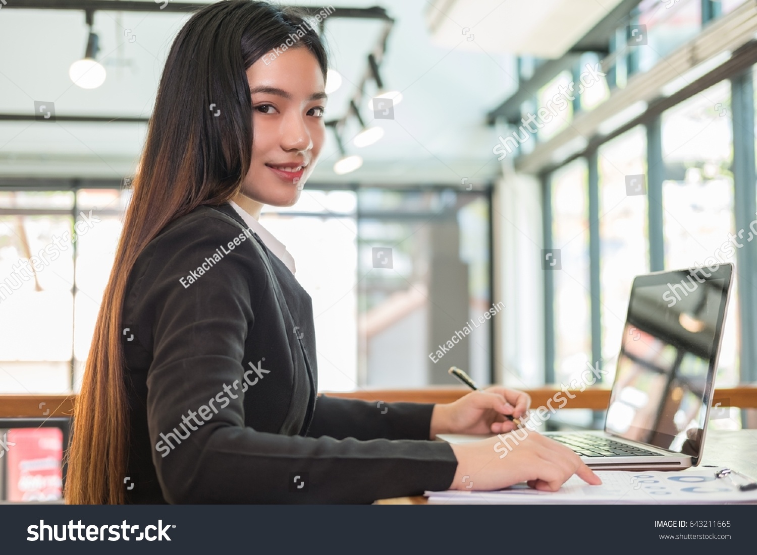 A business woman working on the laptop at the office #643211665