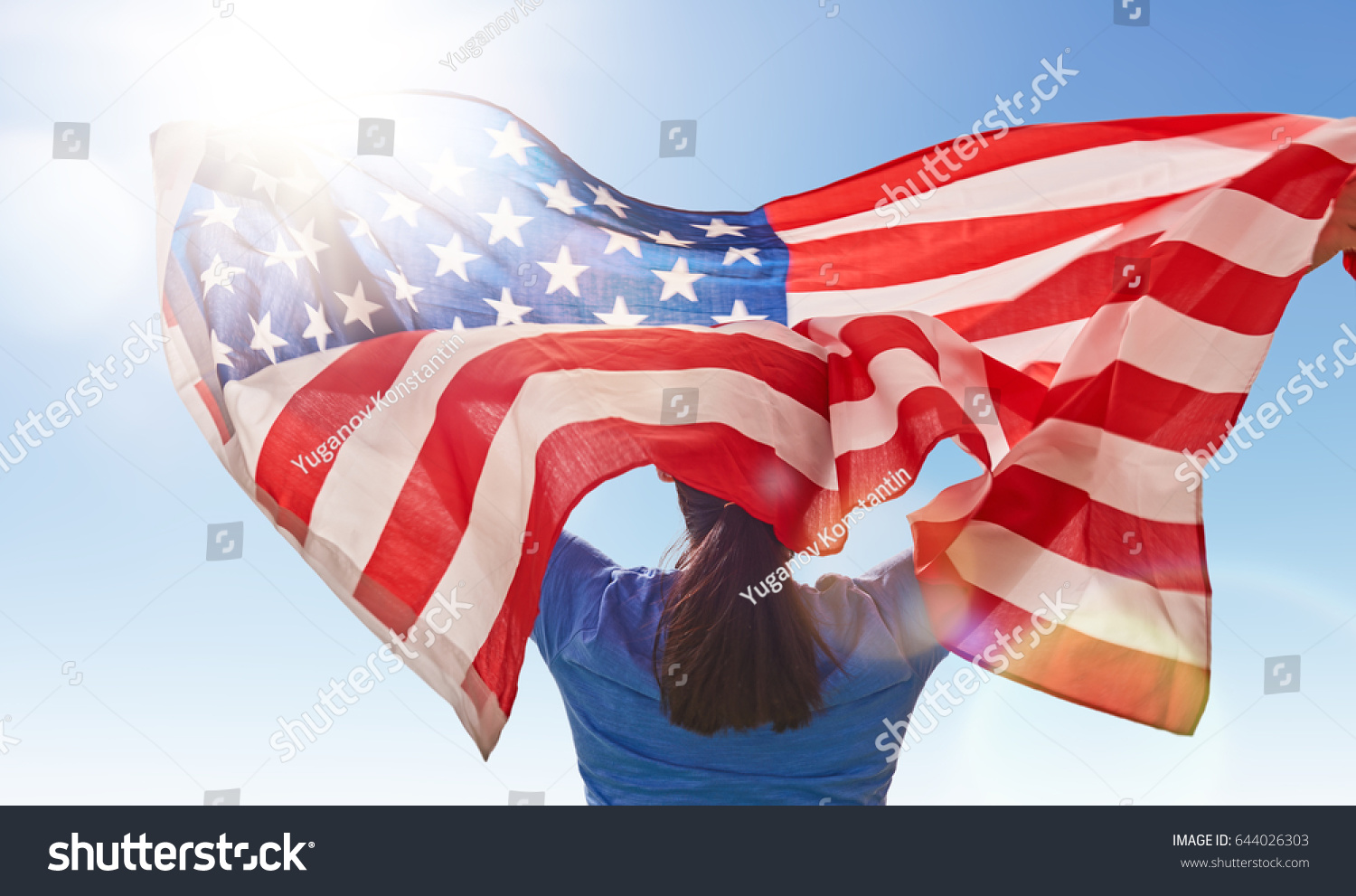 Patriotic holiday. Happy young woman with American flag. USA celebrate 4th of July. #644026303
