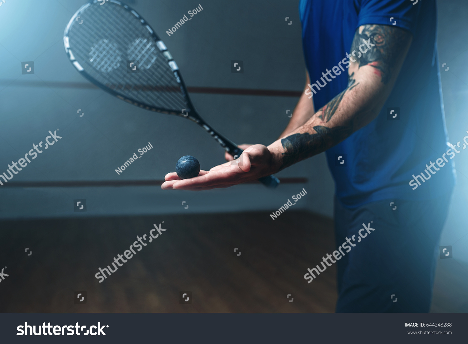 Male squash player training on indoor court #644248288