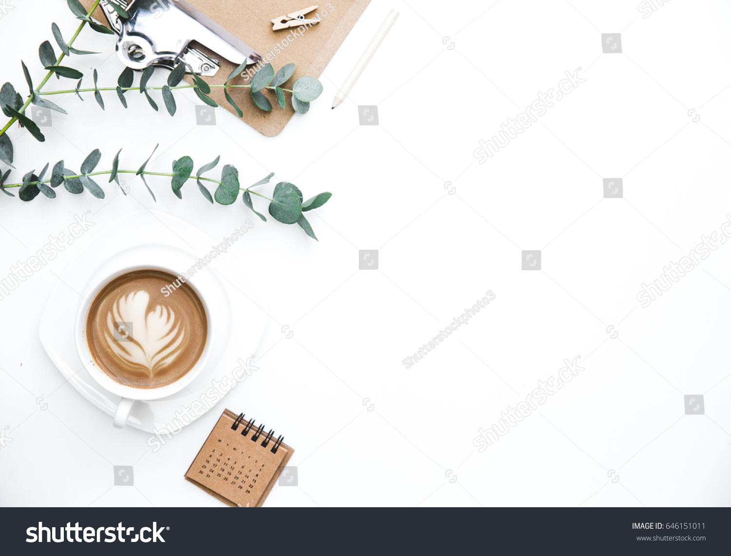 Flay lay, Top view office table desk. Feminine desk workspace frame with green leaves eucalyptus, clipboard and coffee  on white background.  ideas, notes or plan writing concept #646151011
