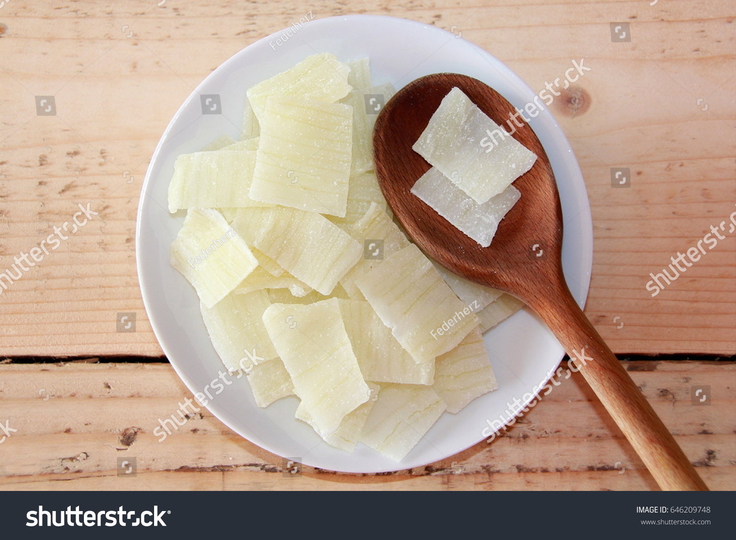 Sliced Aloe Vera on a white plate with a wooden spoon #646209748