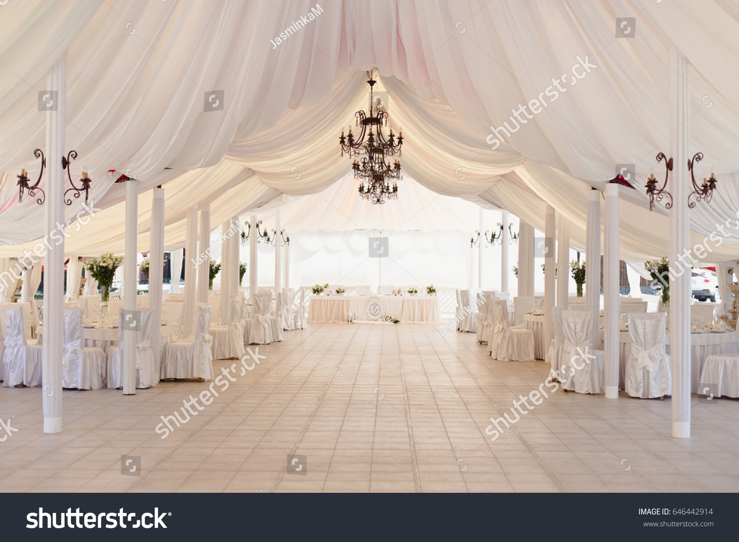 Marquee for the celebration of the wedding. Beautiful white interior with white draperies #646442914