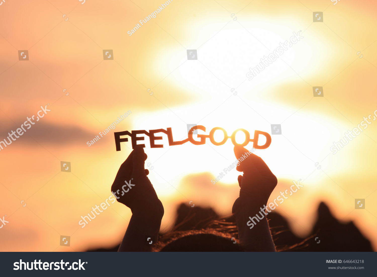 FEEL GOOD text in hands on the sunset sky #646643218