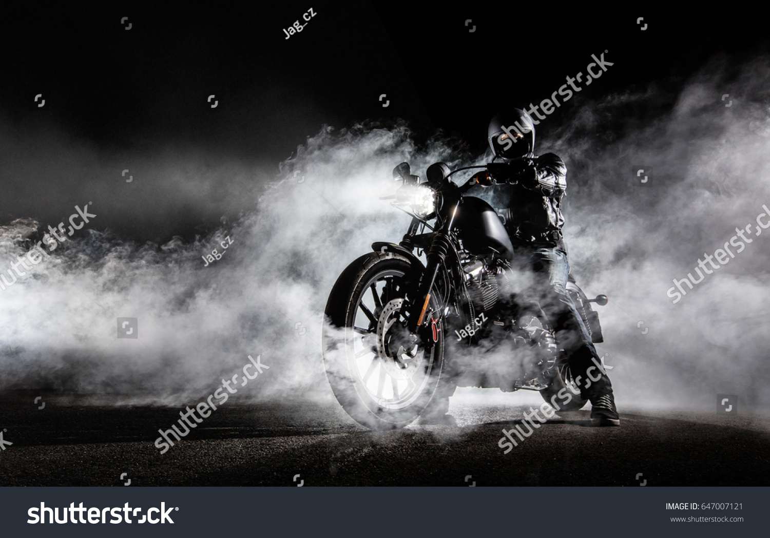 High power motorcycle chopper with man rider at night. Fog with backlights on background. #647007121