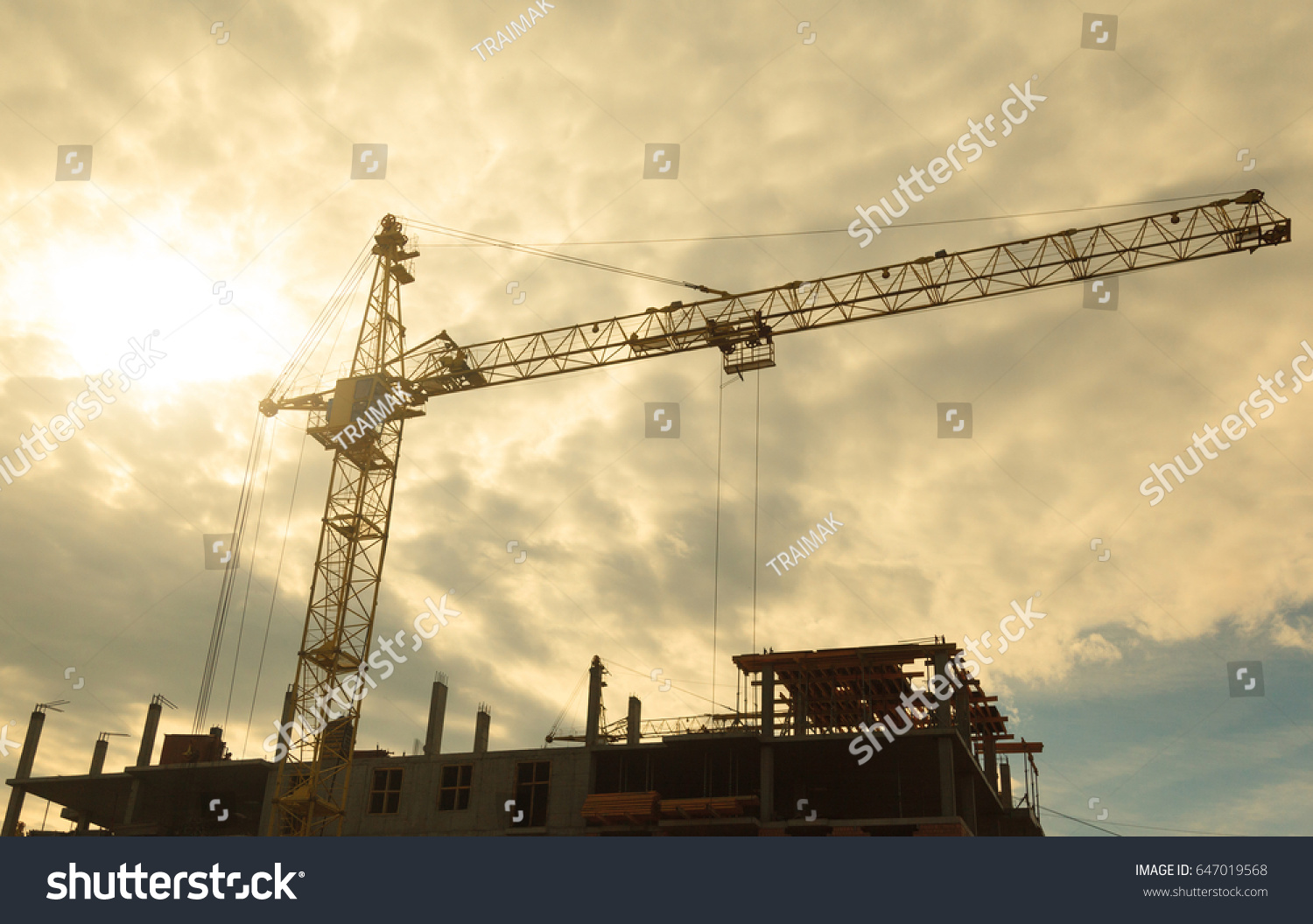 Building crane orange in the background of the sky and the object under construction #647019568