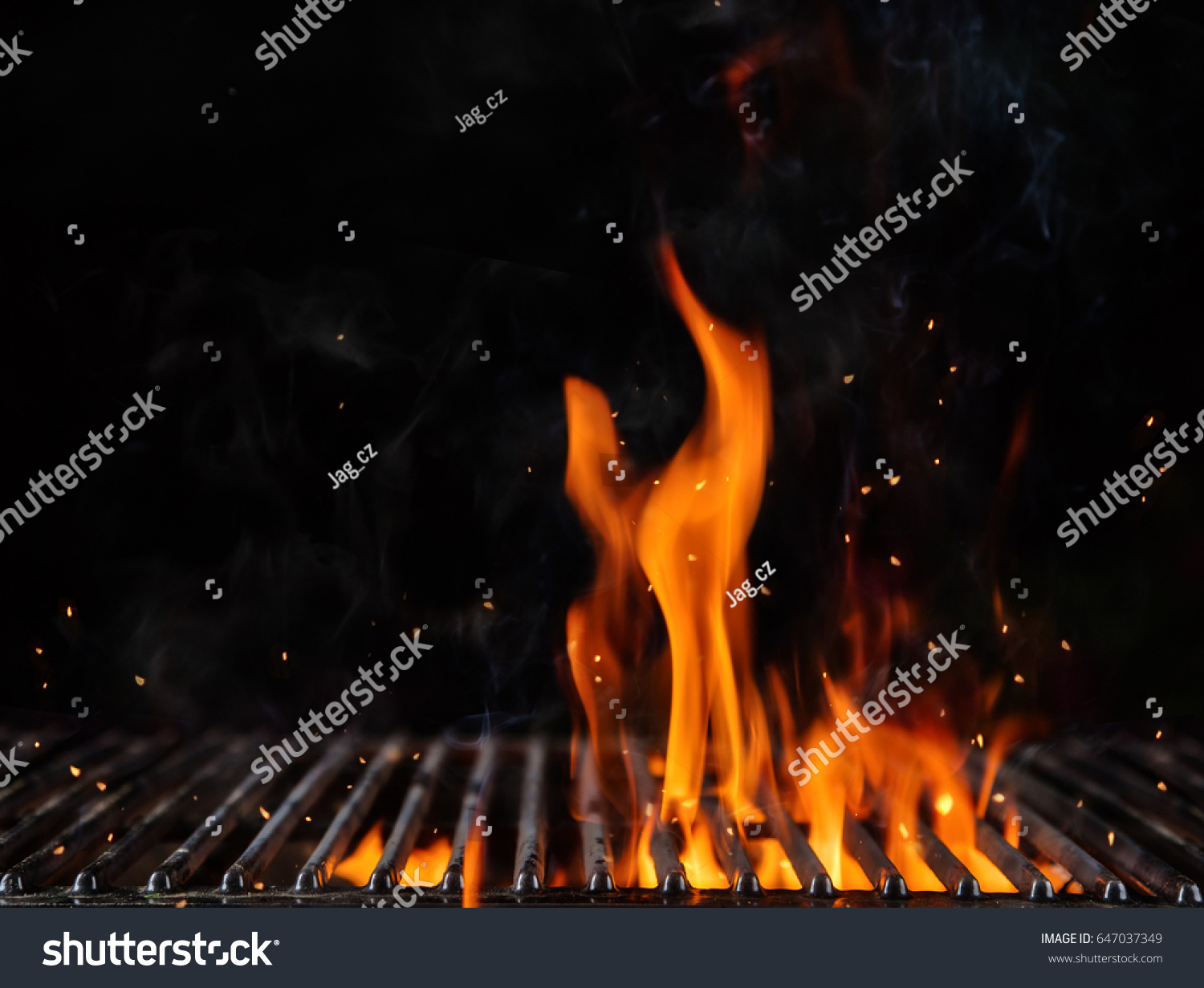 Empty flaming charcoal grill with open fire, ready for product placement. Concept of summer grilling, barbecue, bbq and party. Black copyspace #647037349