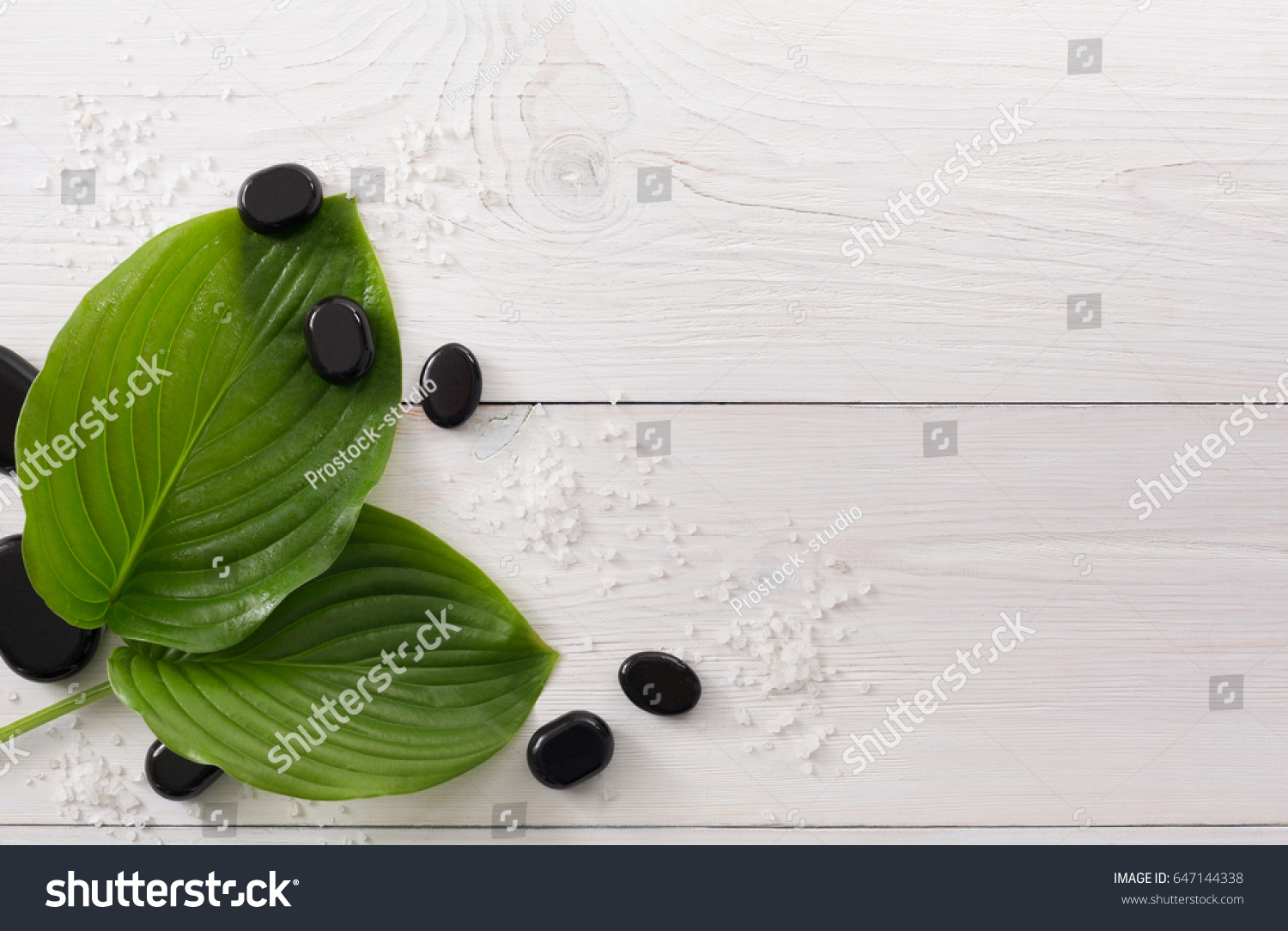 Spa treatment and aromatherapy top view background. Zen black marble stones, aroma salt for wellness beauty parlor. White wood with copy space #647144338