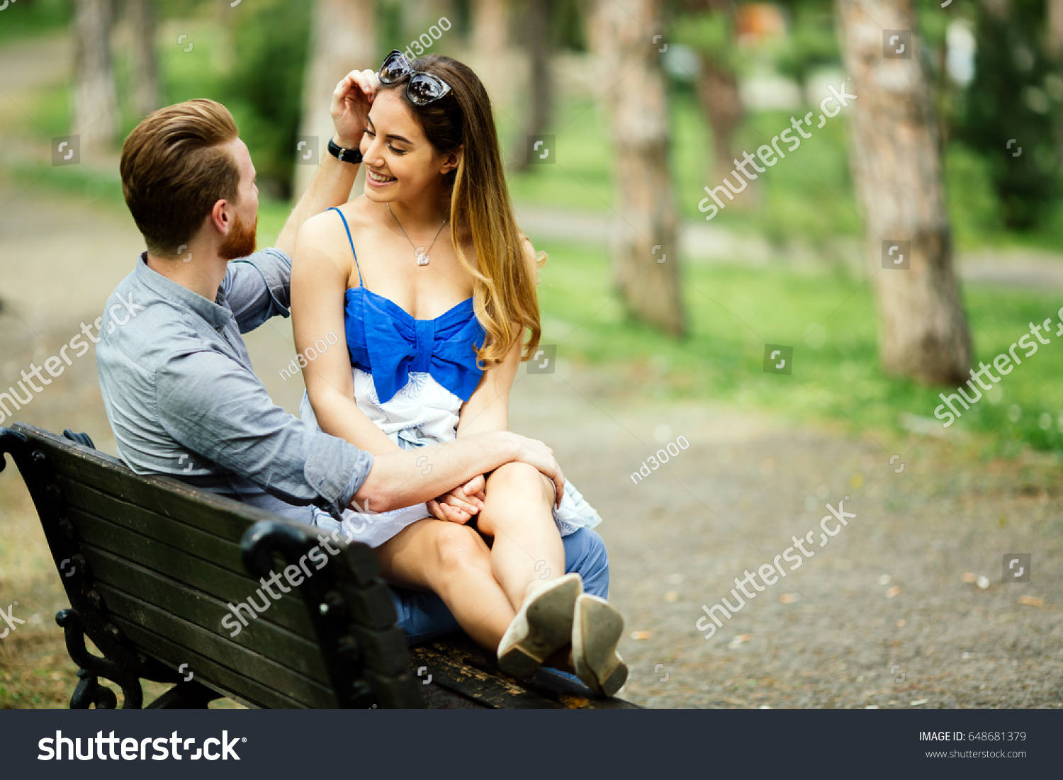 Dating couple sitting on bench #648681379