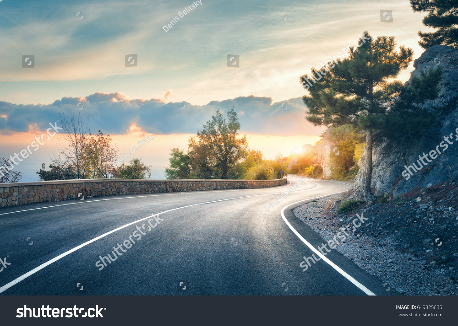 Mountain road. Landscape with rocks, sunny sky with clouds and beautiful asphalt road in the evening in summer. Vintage toning. Travel background. Highway in mountains. Transportation #649325635
