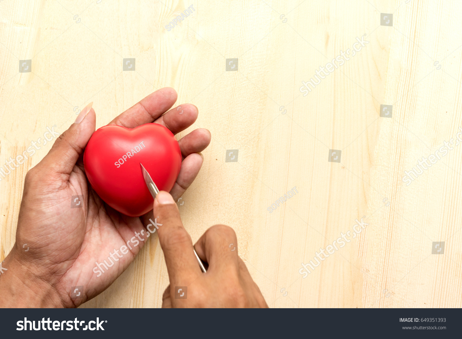 red  pillow heart in hand with Surgery concept #649351393