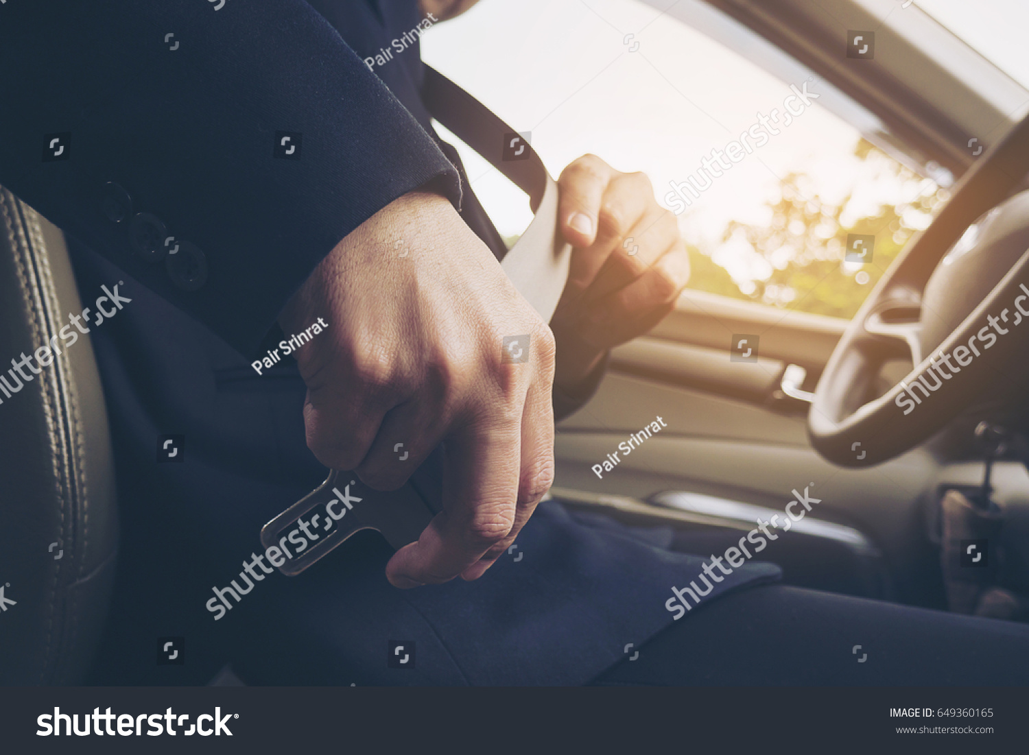 Man putting car seat belt before driving, close up at belt buckle, safe drive concept #649360165