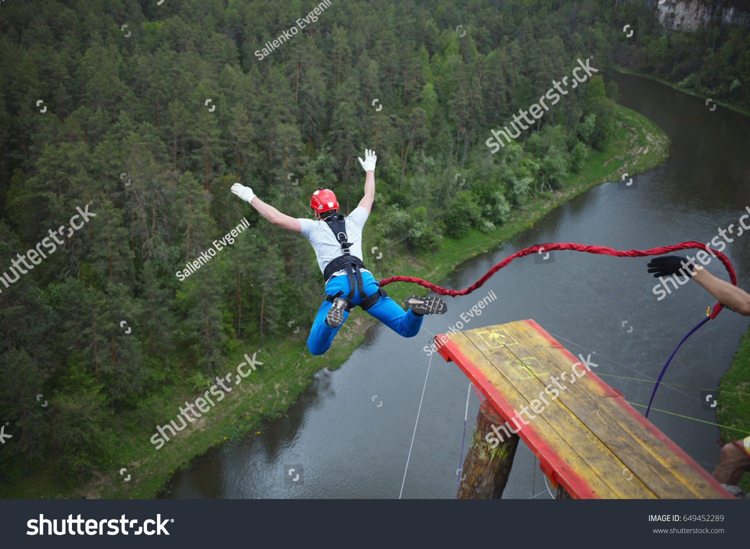 An extreme sportsman jumps on a rope from a great height. Ropejumping. #649452289