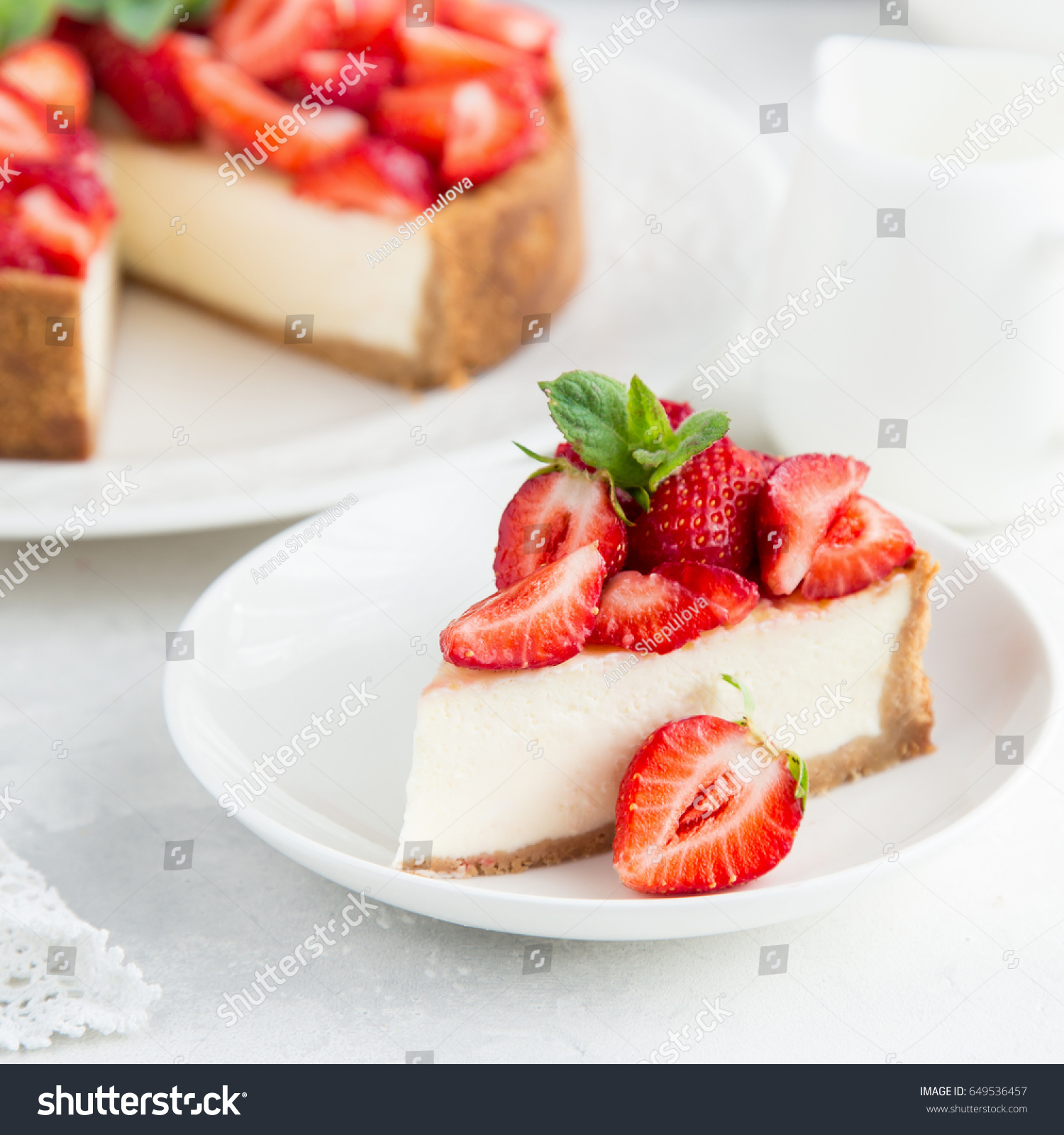 slice of strawberry cheesecake on white background, selective focus, square image #649536457