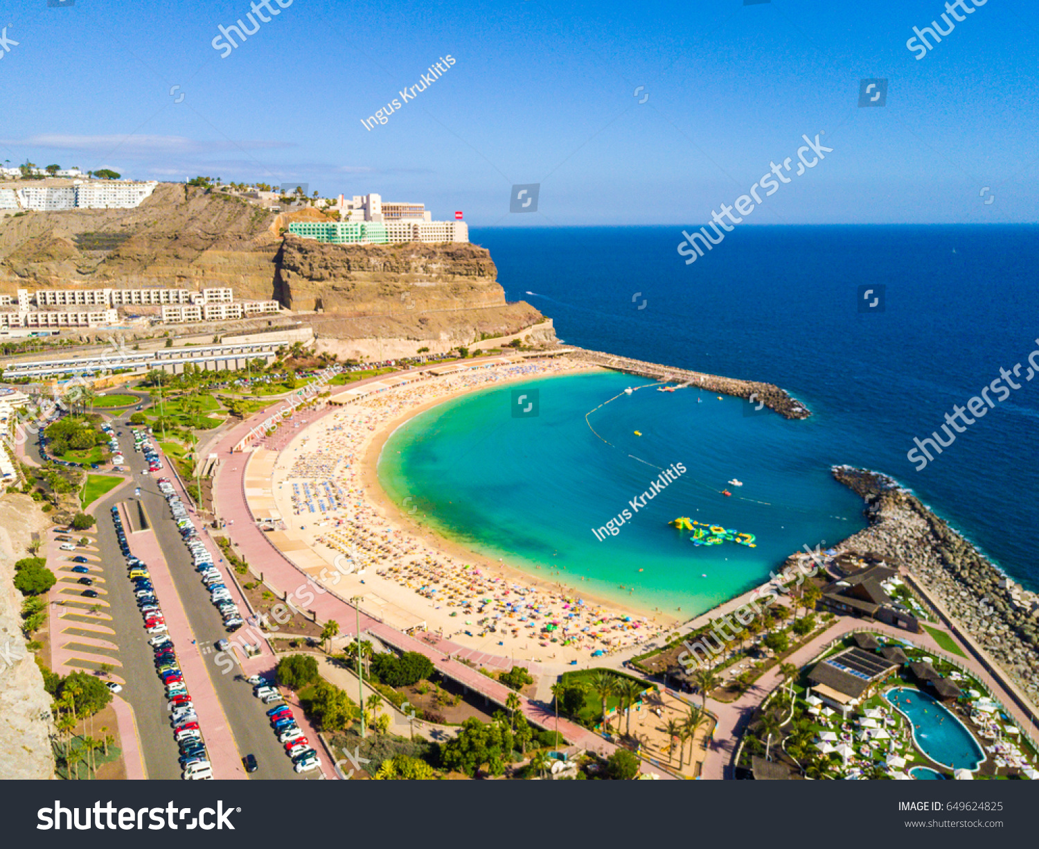 Amazing aerial view of Playa de Amadores beach on the Gran Canaria island in Spain. Beautiful sea shore with cliffs of the island. #649624825