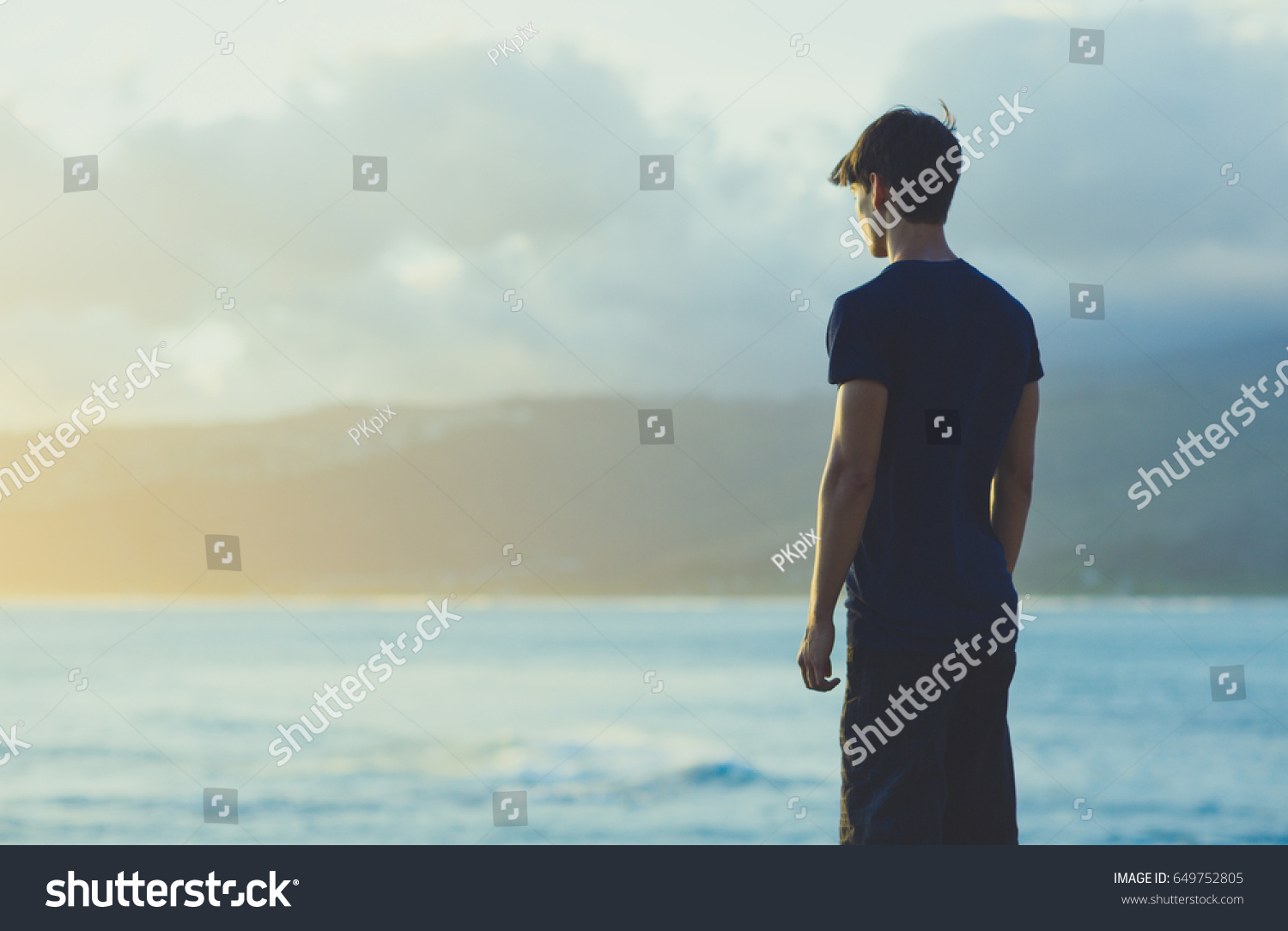 Standing Man watching the ocean view Sunrise. #649752805