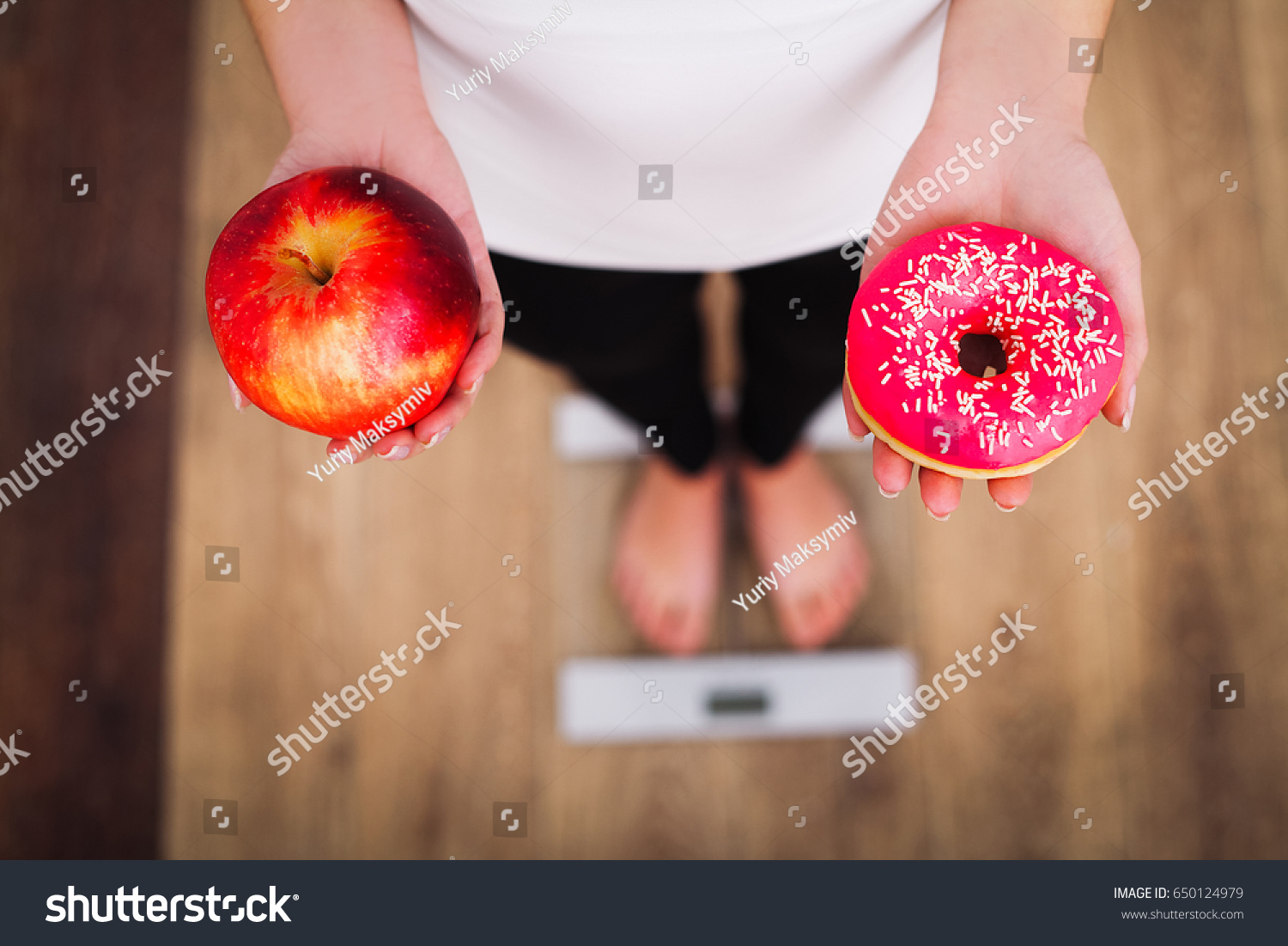Diet. Woman Measuring Body Weight On Weighing Scale Holding Donut and apple. Sweets Are Unhealthy Junk Food. Dieting, Healthy Eating, Lifestyle. Weight Loss. Obesity. Top View #650124979