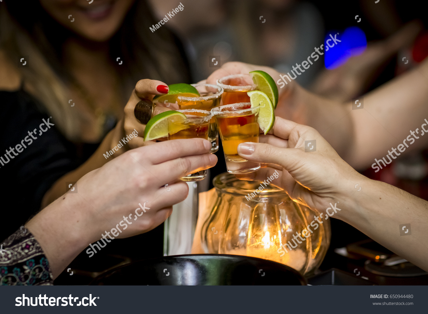 Girls making a toast with tequila shots #650944480