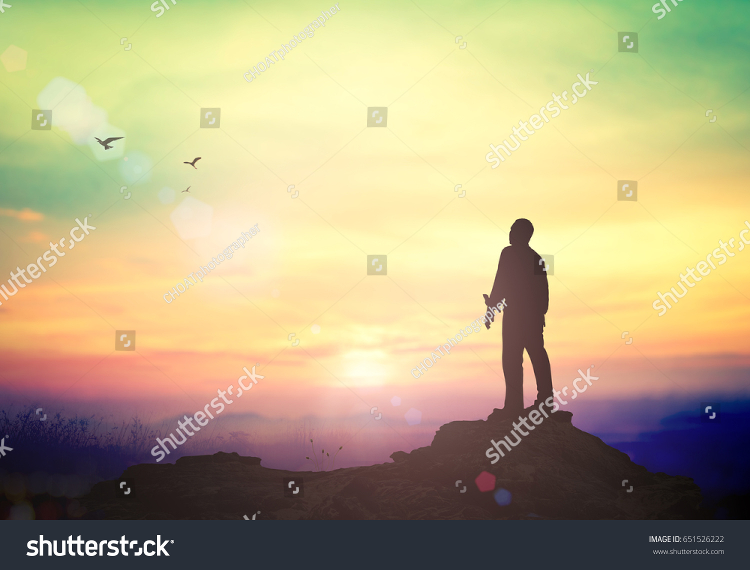 International migrants day concept: Silhouette of humble business man standing on mountain autumn sunset background #651526222