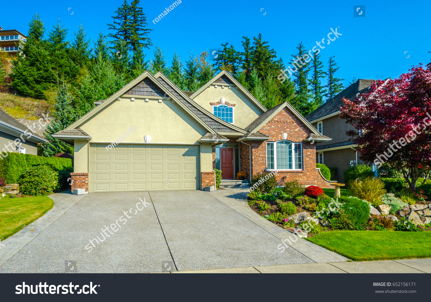 Big custom made luxury house with nicely landscaped and trimmed front yard in the suburbs of Vancouver, Canada. #652156171