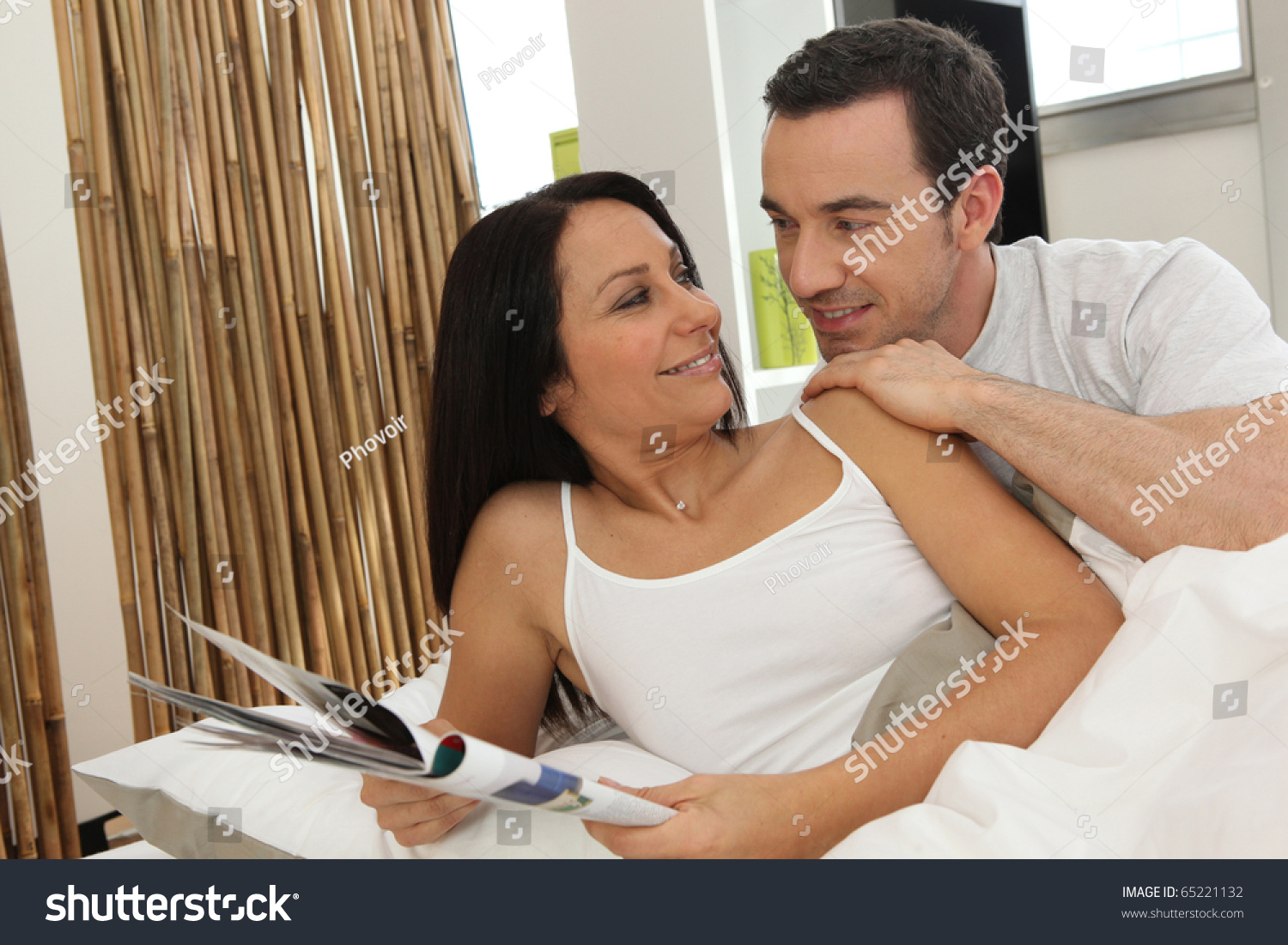 Couple relaxing in bed #65221132