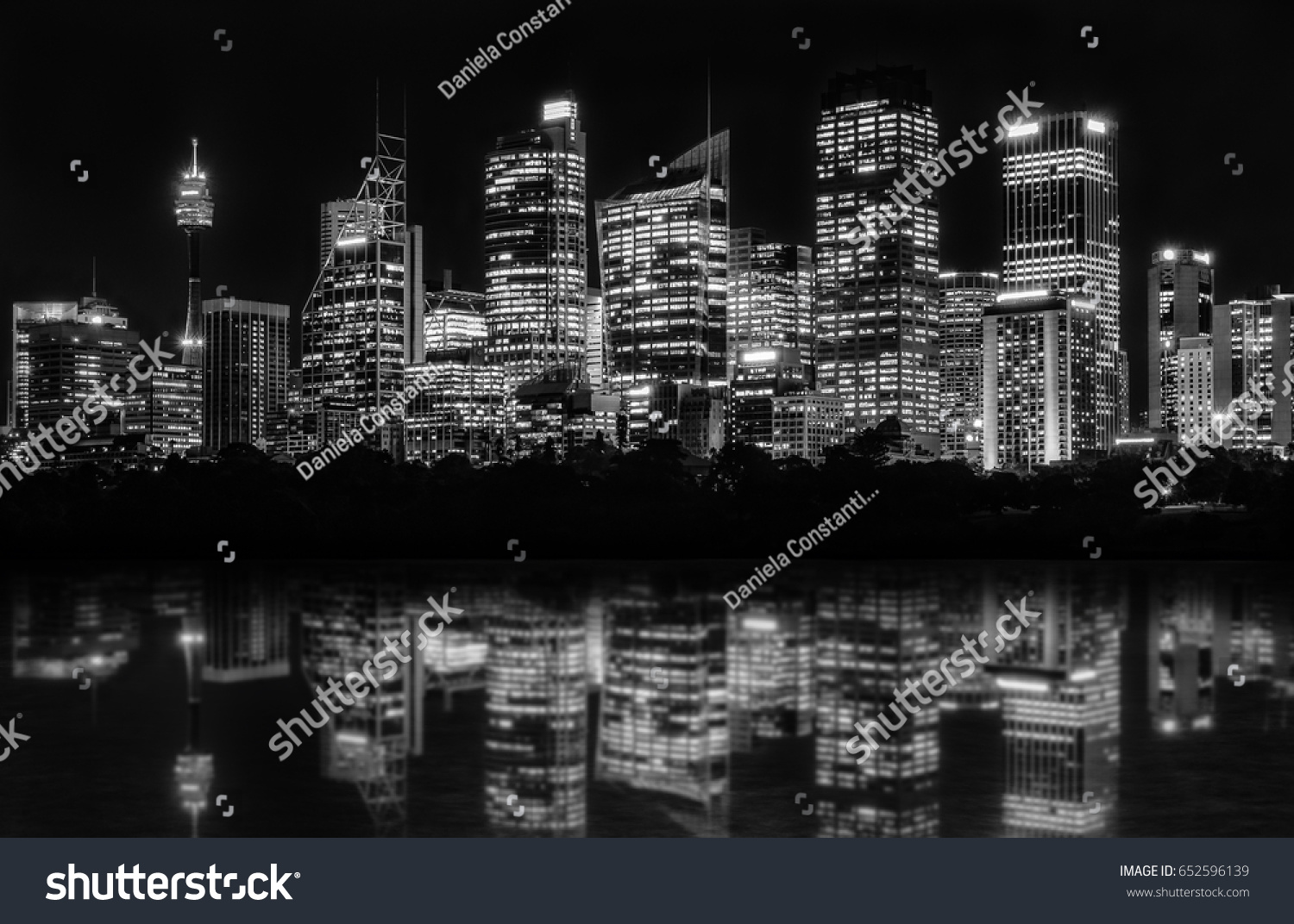 Beautiful Sydney Skyline at night in black and white of Central Business District seen from Farm Cove, with reflections in bay's water. #652596139