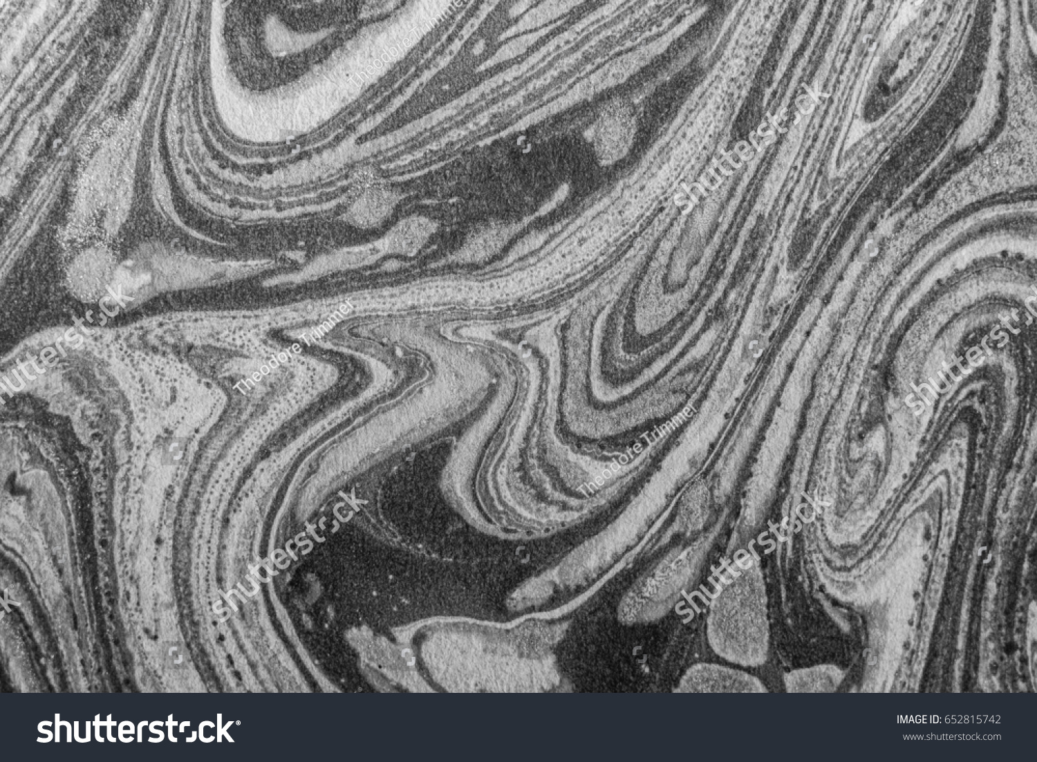 Swirled Paint on Cement Sidewalk.  Black and white photograph of layers of paint. #652815742