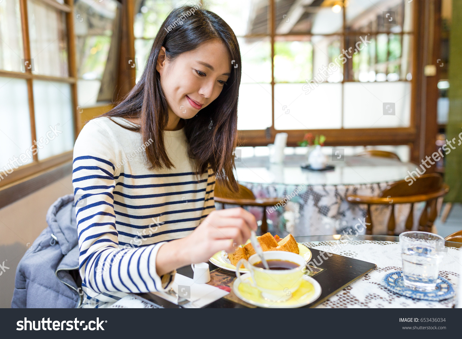 Woman enjoy her breakfast #653436034