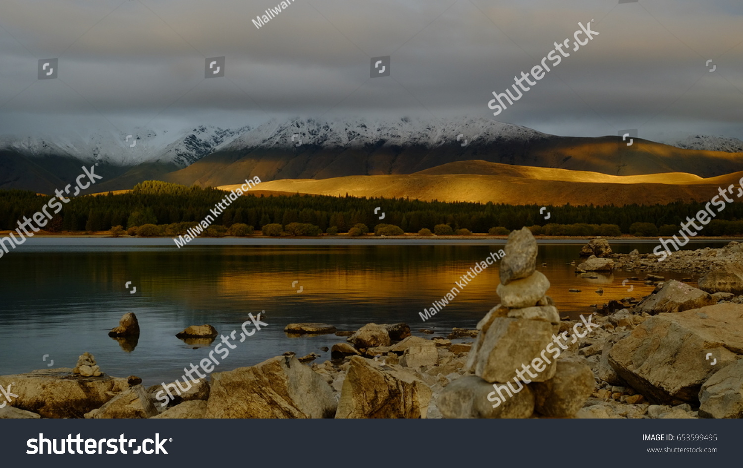 golden light  shine on the  mountain then reflect in water of lake .awesome background  #653599495