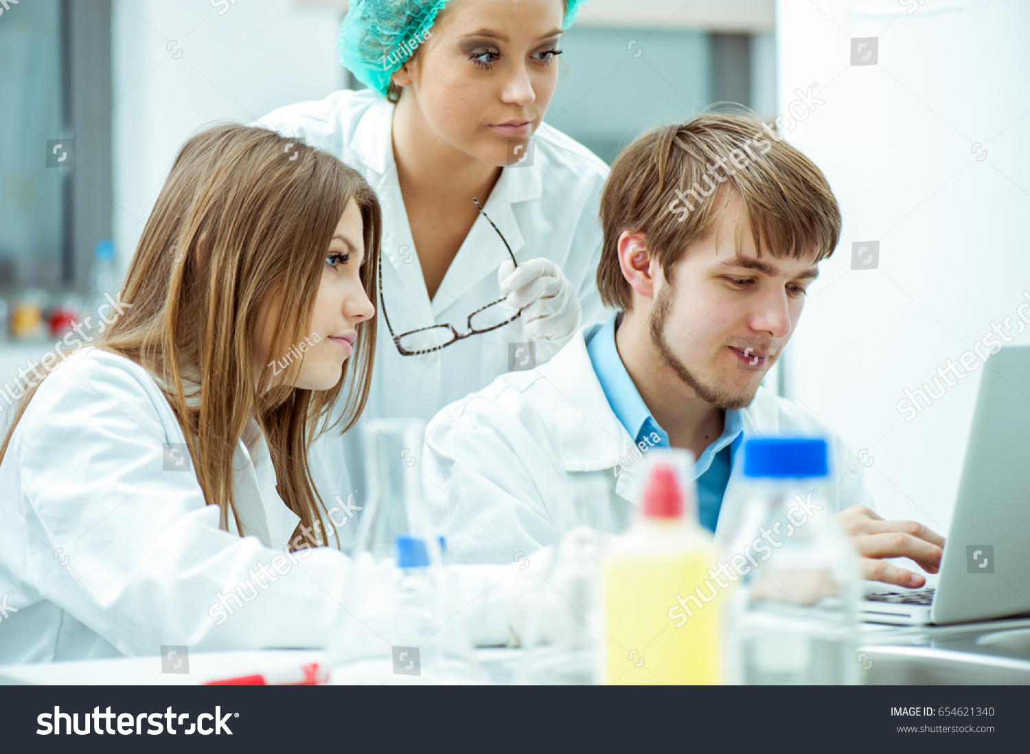 a group of lab experts working in a lab #654621340