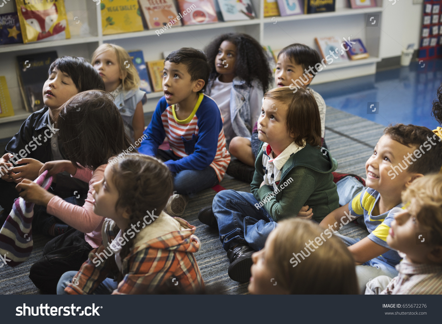 Kindergarten students sitting on the floor #655672276