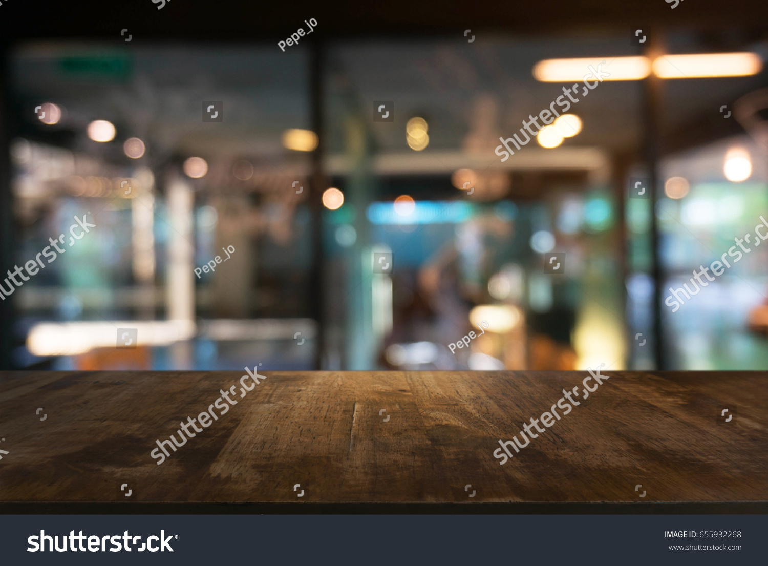Empty wooden table in front of abstract blurred background of coffee shop . can be used for display or montage your products.Mock up for display of product #655932268