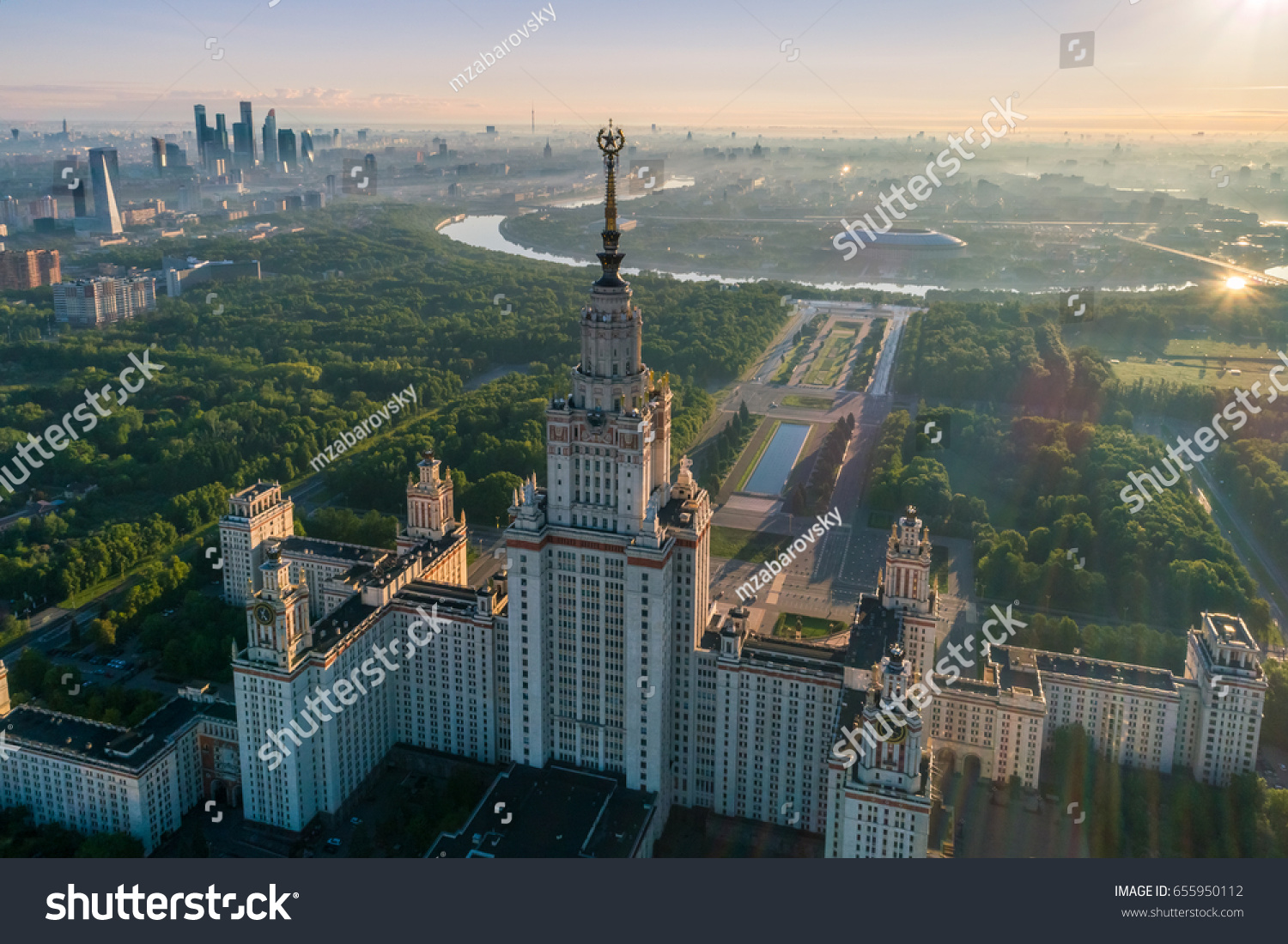 Moscow state university and Moscow city business center at sunrise. City in fog. Russia. Aerial View. #655950112