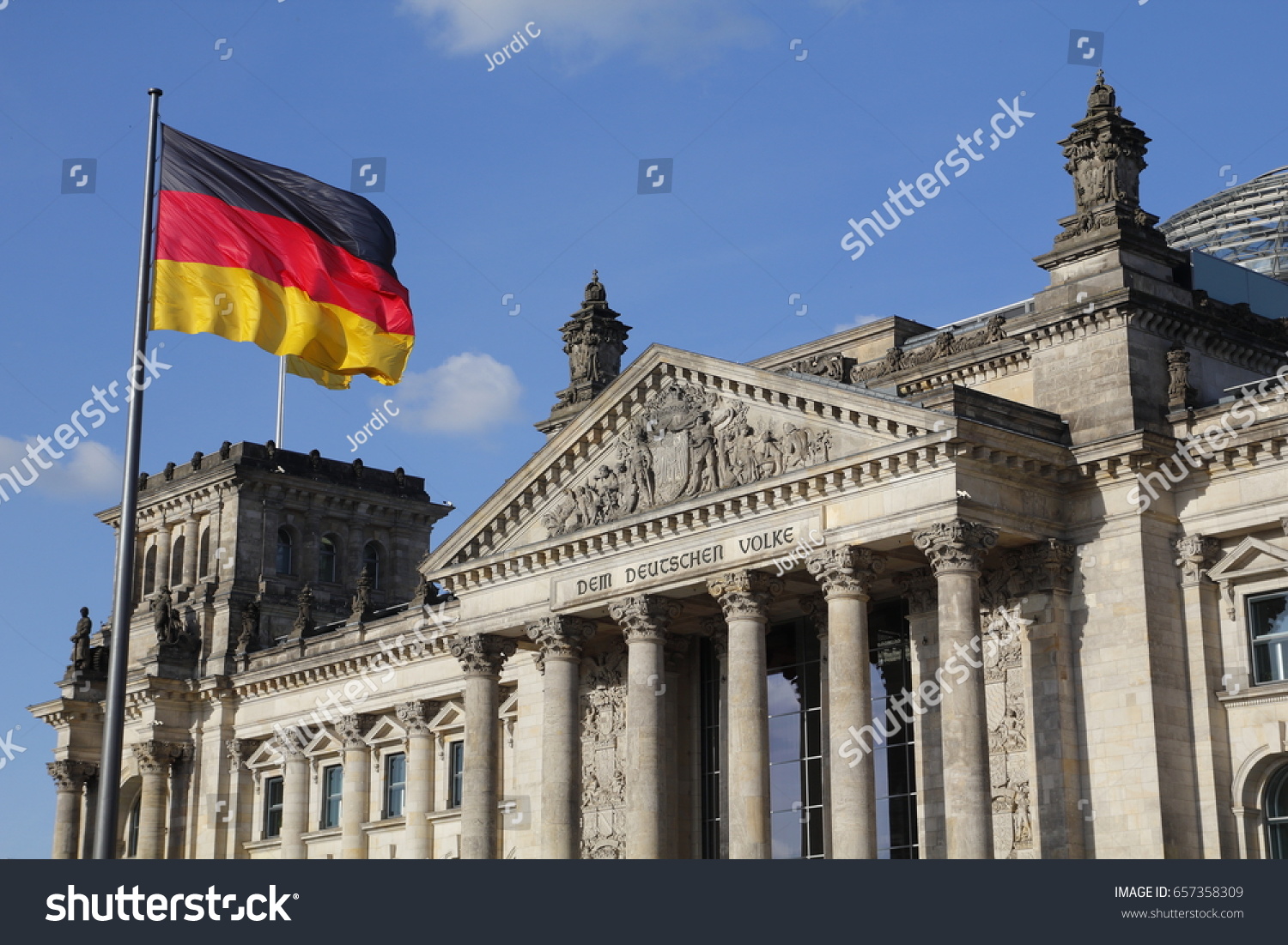 The German Bundestag with flag, a constitutional and legislative building in Berlin, capital of Germany #657358309