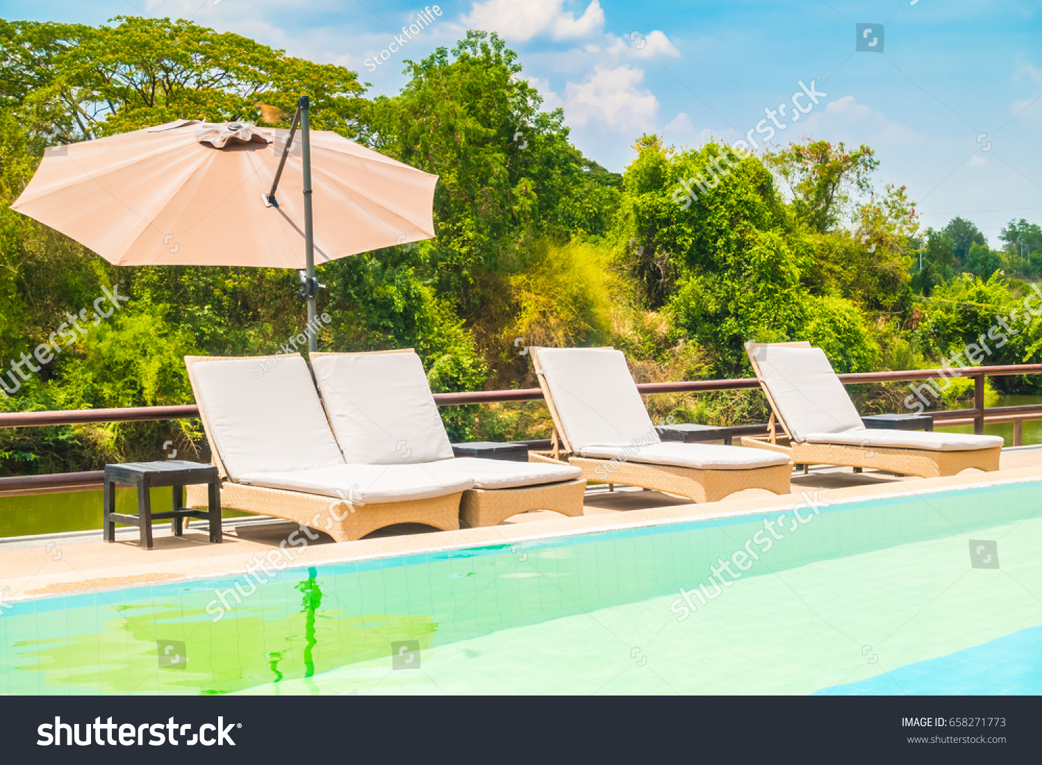 Umbrella and chair with swimming pool and outdoor view around hotel and resort #658271773