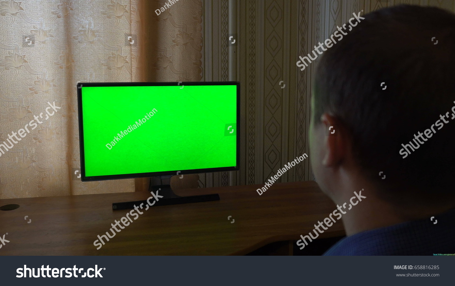 Male Hand With TV Remote Switching Channels On A Green Screen TV Point Of View. #658816285