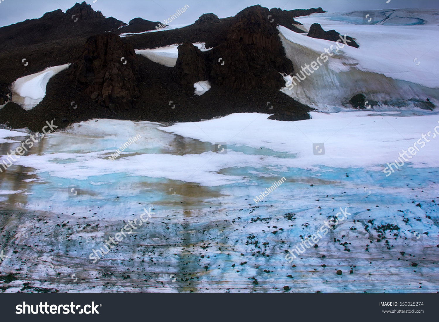 Melting of glaciers in high arctic zone. Currently, there are stones which are on glacier during the Ice age. Arctic, Franz Josef Land #659025274