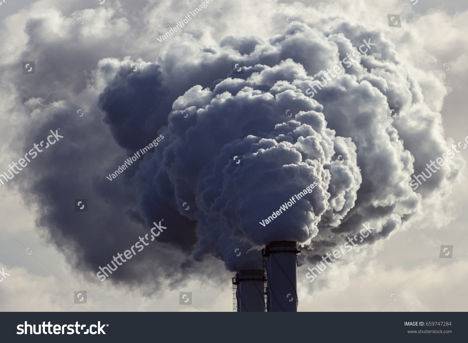 Air pollution from power plant chimneys. #659747284