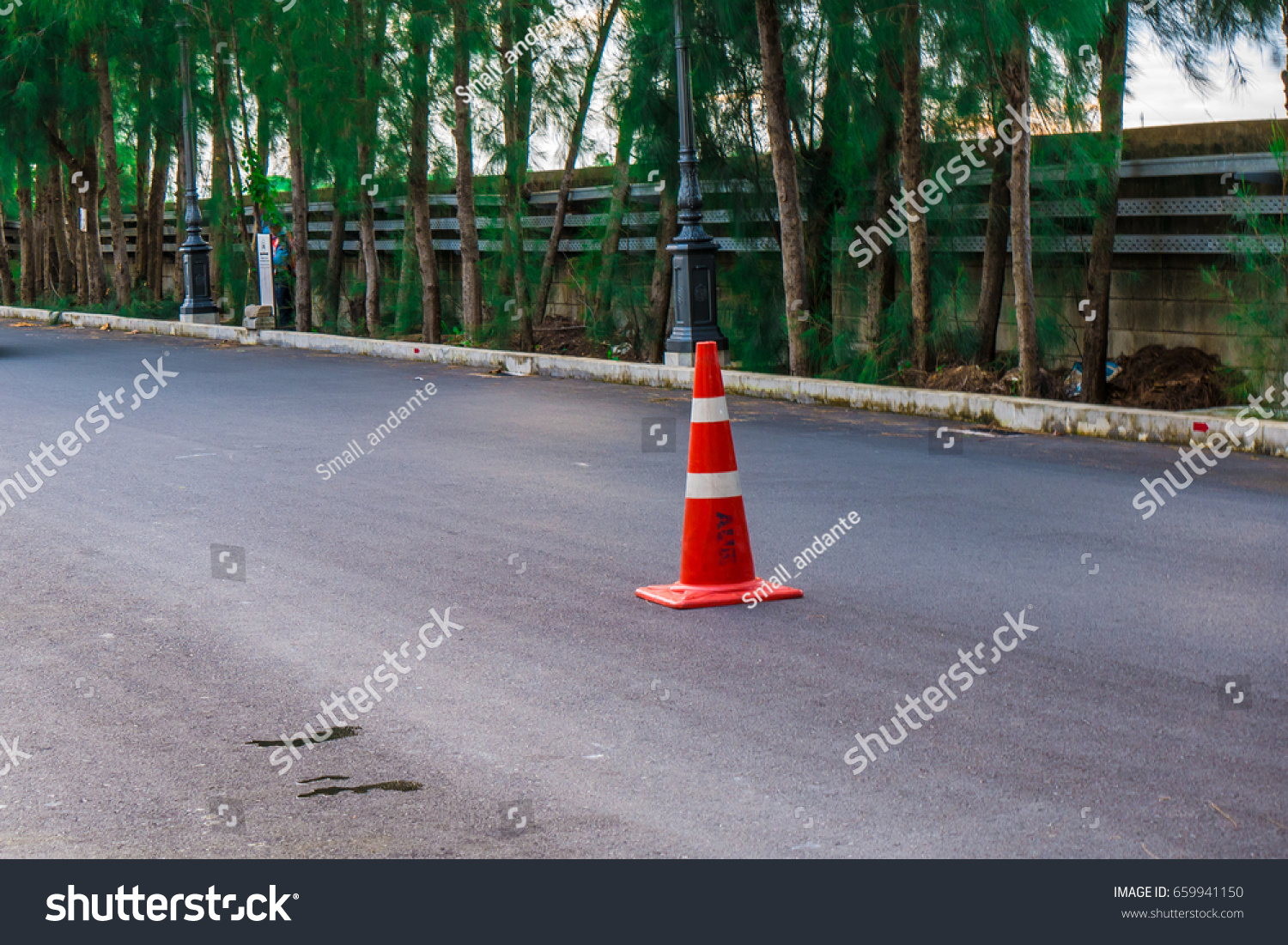 Orange traffic cone on street #659941150