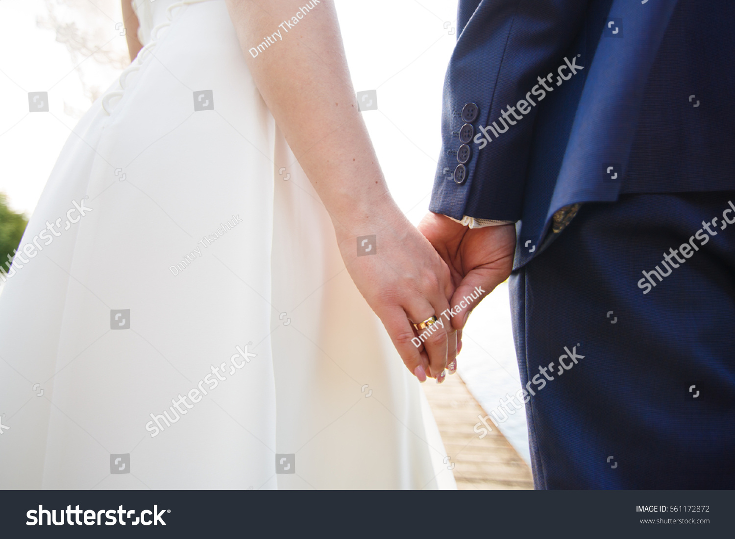 Newly married gently hold hands #661172872