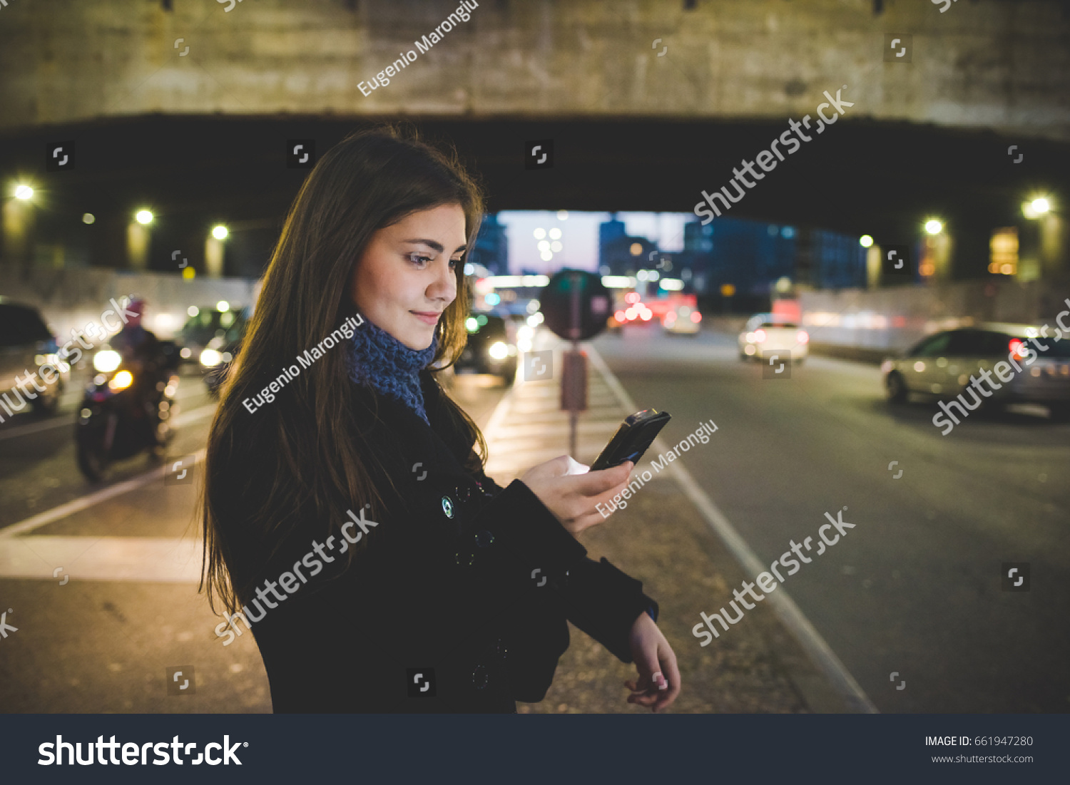 YOung woman outdoor using smart phone hand hold face illuminated by screen light - social network, communication, technology concept #661947280