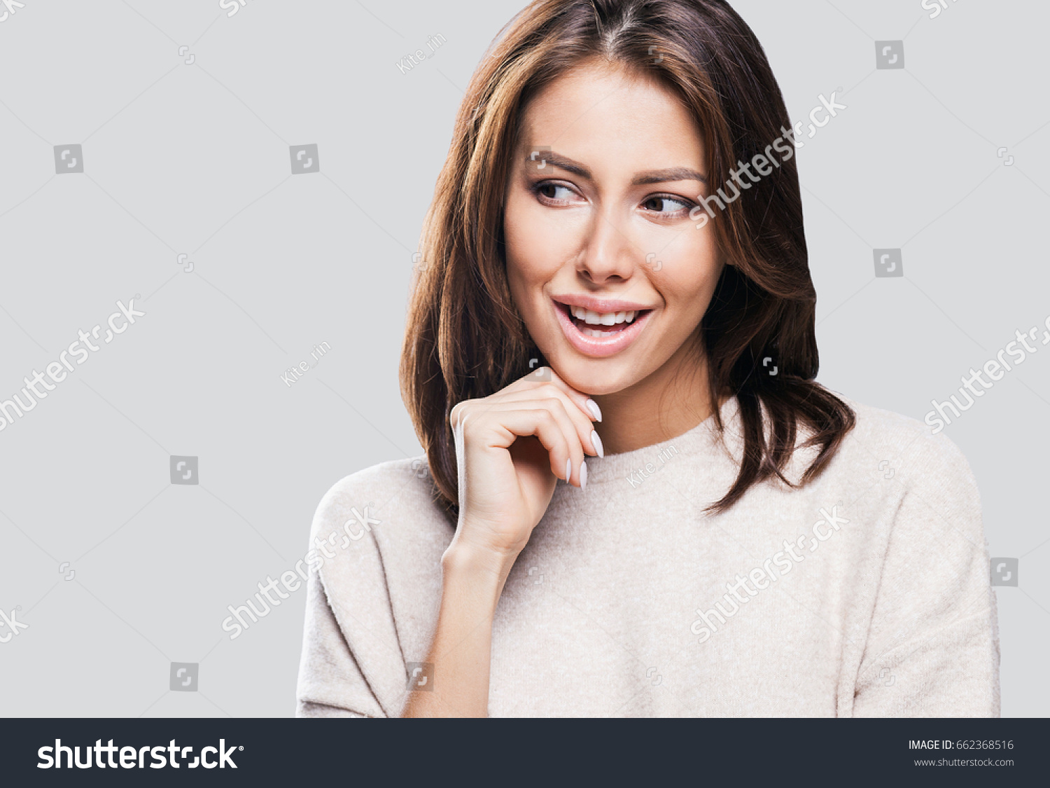 Studio portrait of a beautiful young woman with brown hair. Pretty model girl looking away #662368516