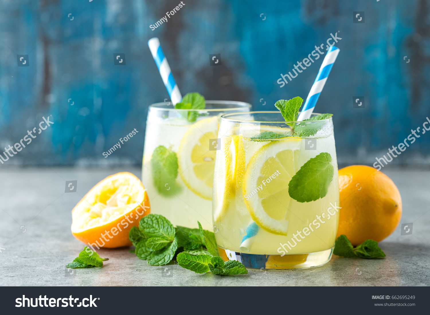 Lemonade or mojito cocktail with lemon and mint, cold refreshing drink or beverage with ice
 #662695249