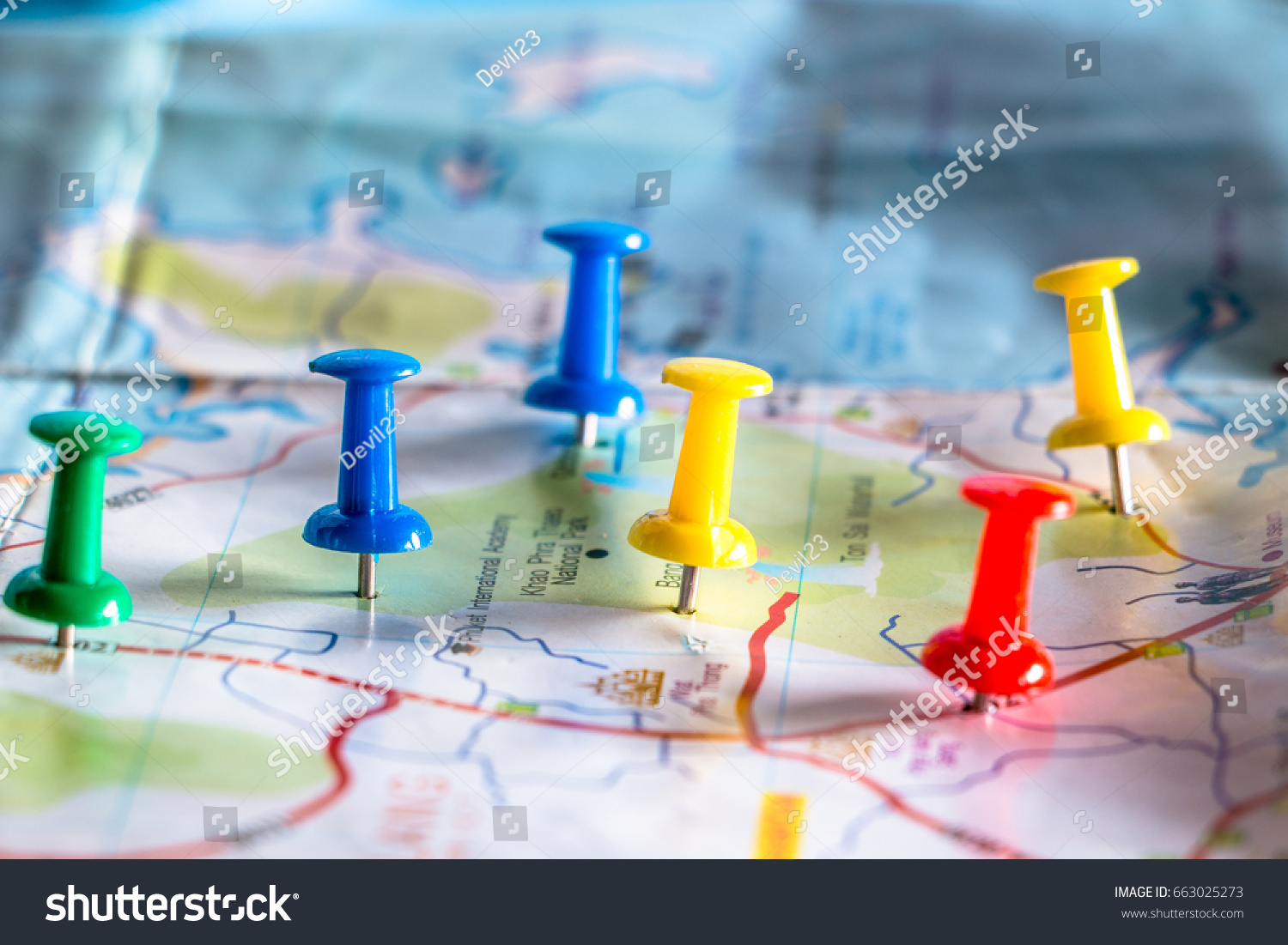 Travel destination pin points on a map with colorful thumbtacks and depth of field with select focus. #663025273